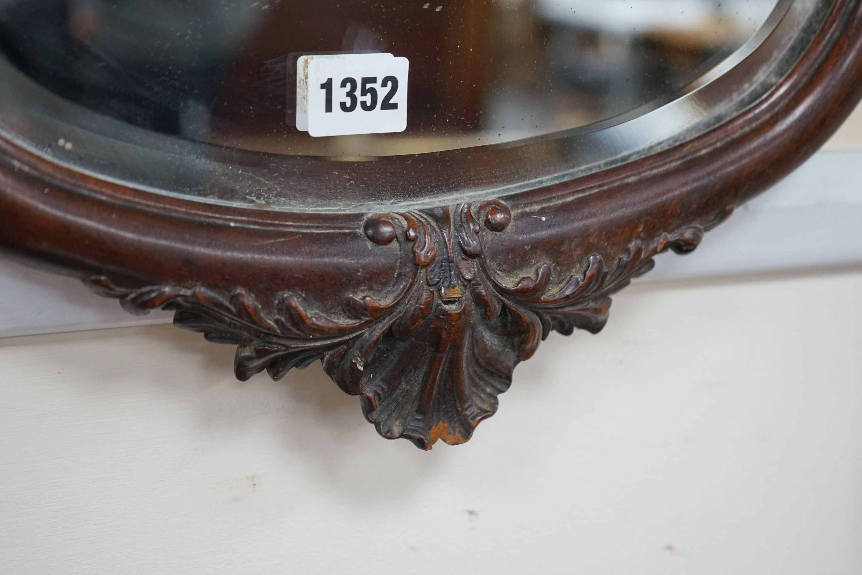 An early 20th century mahogany oval wall mirror, width 74cm, height 94cm